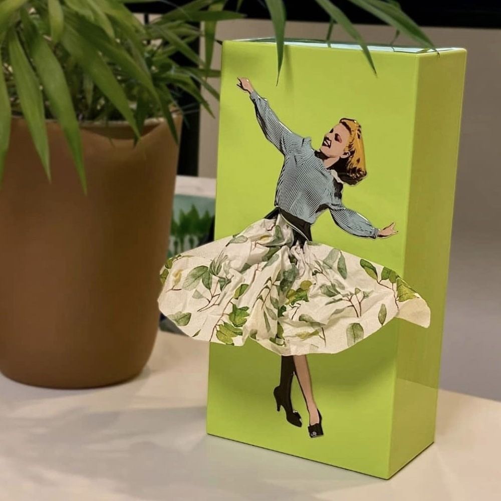 Interactive flying skirt tissue box in purple. Novelty tissue dispenser for bathroom or desk.