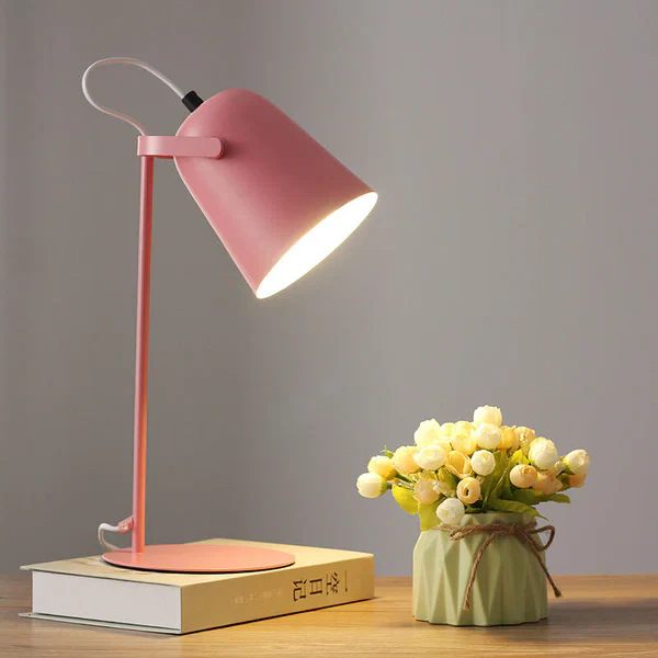 Whimsical Macaron Iron Bucket Table Lamp providing soft ambient lighting for a cozy room.