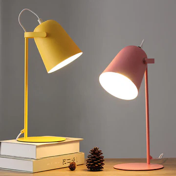 Ambient lighting from a colorful iron macaron desk lamp, perfect for whimsical home decor.