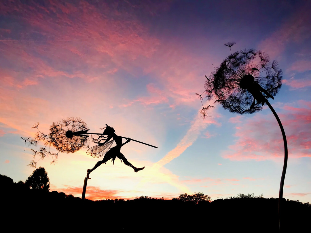 Outdoor yard art: Whimsical metal fairy dancing on a dandelion. Magical garden stake for enchanted decor.