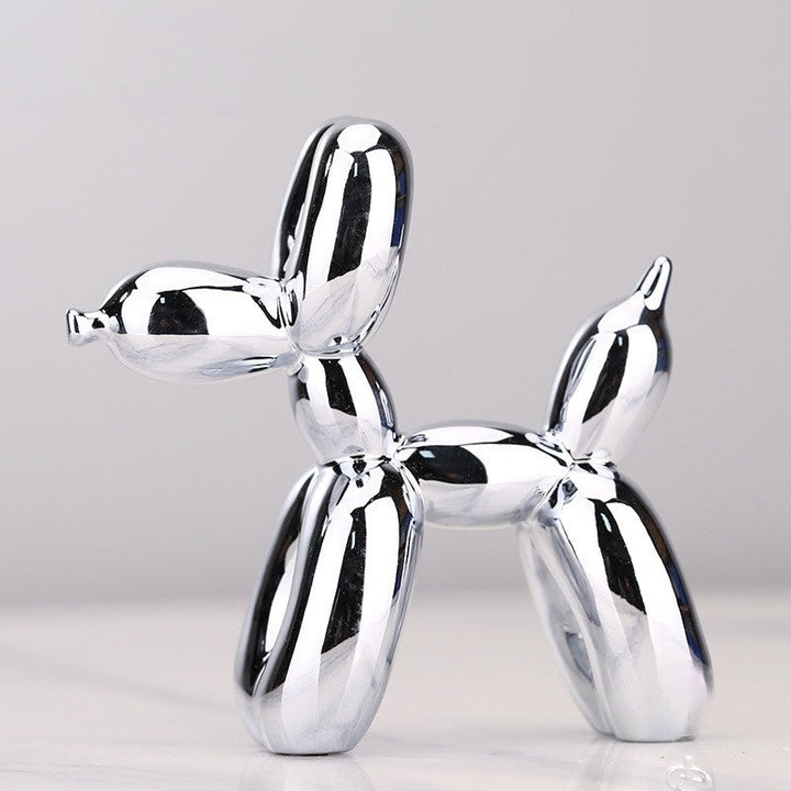 Whimsical metallic balloon dog sculpture. Modern resin figure, playful home decor or unique desktop art accent.