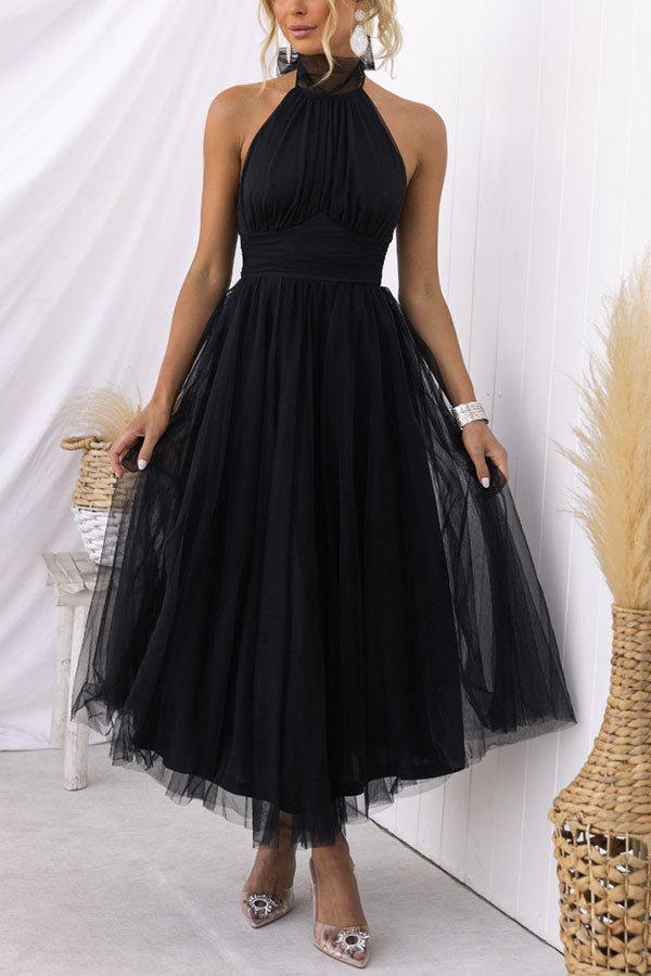 Woman modeling an elegant whimsical tulle midi dress. Perfect wedding guest, formal, or special occasion outfit.