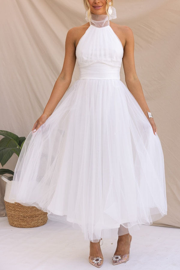 Knee-length whimsical tulle midi dress for women. Elegant A-line special occasion, cocktail, or wedding guest party wear.