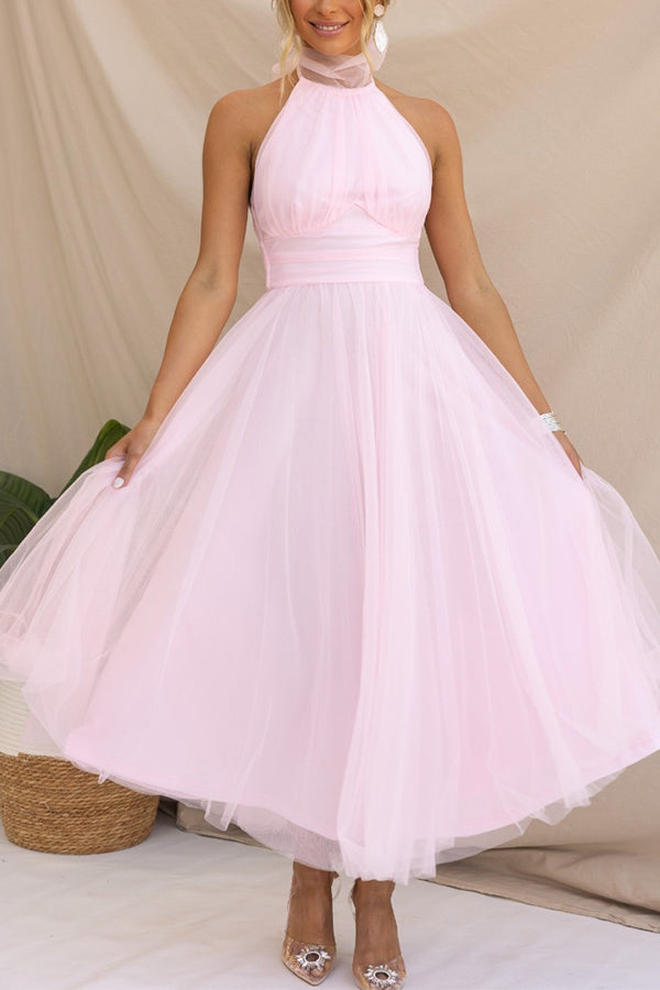 Close-up of delicate tulle fabric on a whimsical midi dress. Elegant women's special occasion or cocktail party gown.
