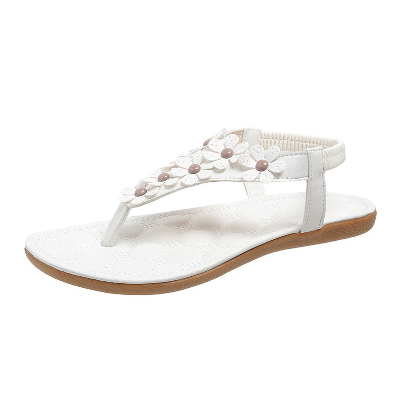Elegant white women's summer sandals with charming floral embellishments, BloomGrace for stylish comfort.