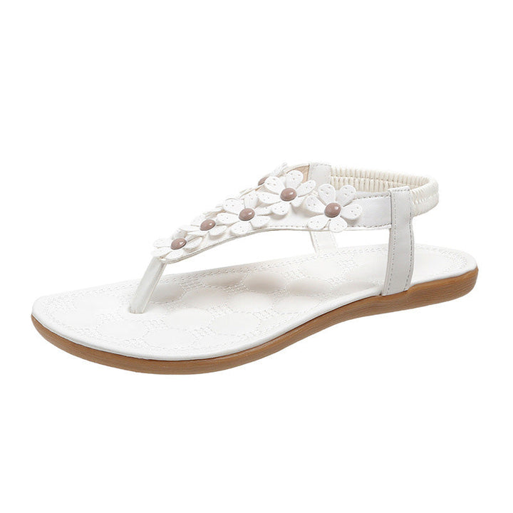 Elegant white women's summer sandals with charming floral embellishments, BloomGrace for stylish comfort.