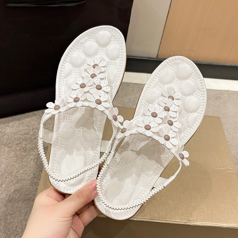 Comfortable women's floral sandals with white straps & intricate flower details, great for casual or dressy looks.