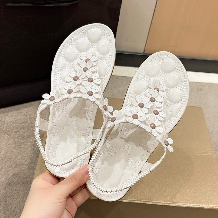 Comfortable women's floral sandals with white straps & intricate flower details, great for casual or dressy looks.