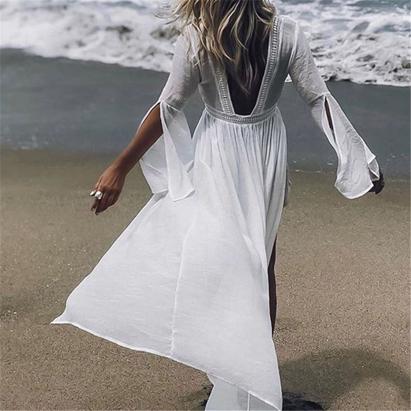 White elegant open back maxi beach dress with flare sleeves, perfect for resort wear or summer vacation.