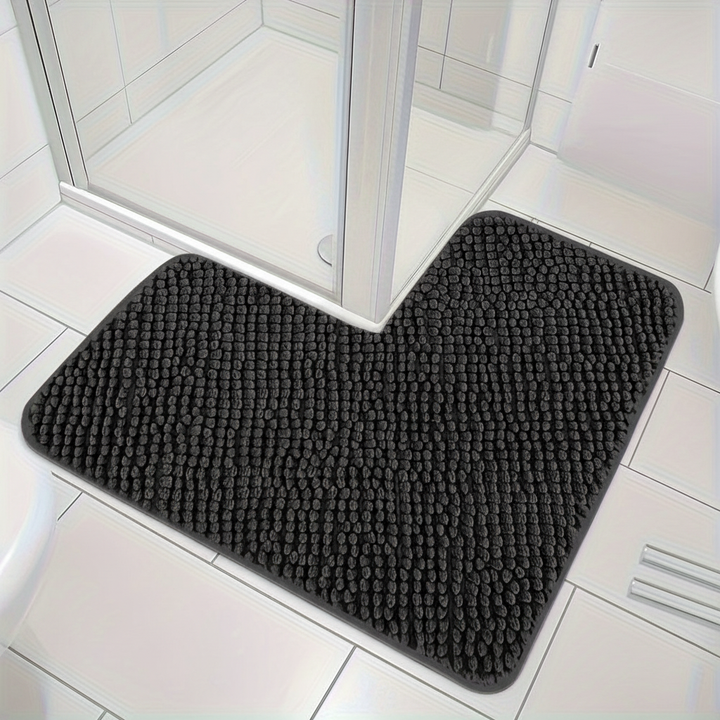 White L-shaped corner bath mat in a shower, soft and absorbent for bathroom comfort and floor safety.