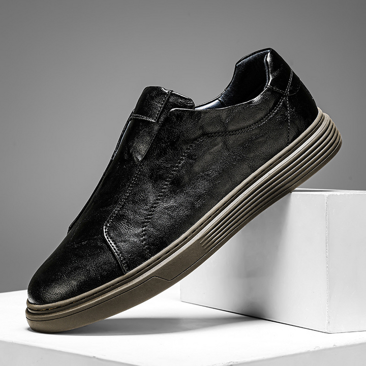 Stylish black low-top sneakers for men. Hand-finished, versatile everyday footwear.