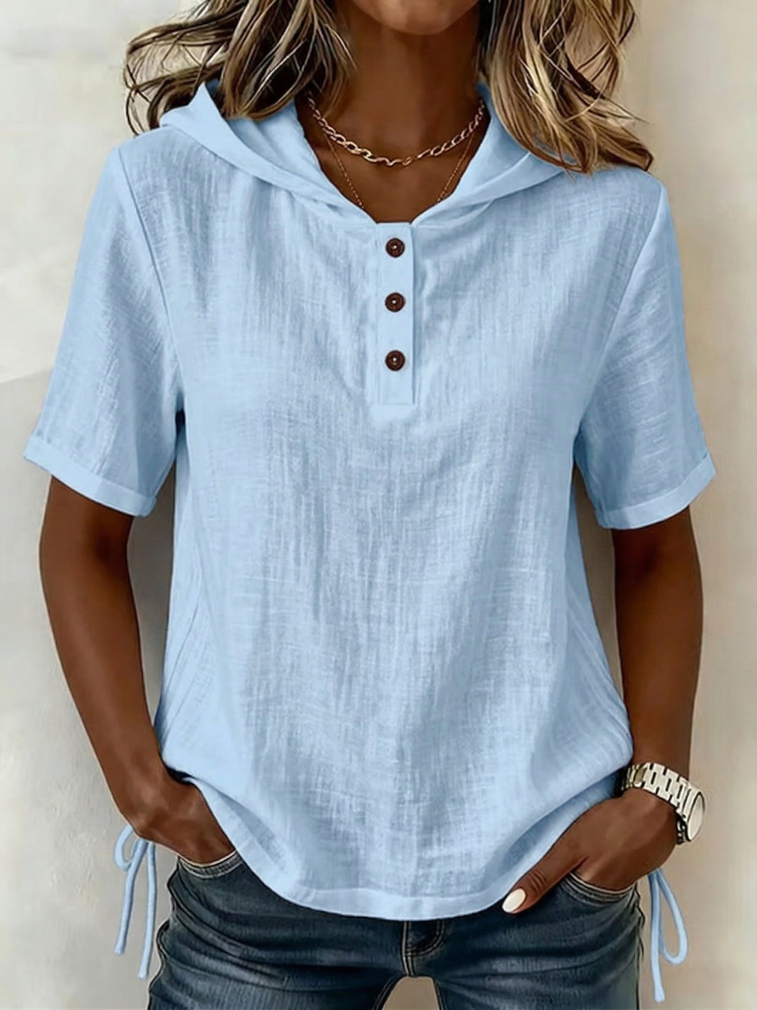 Model wearing a women's white casual hooded shirt, highlighting its comfortable, effortless spring fashion.