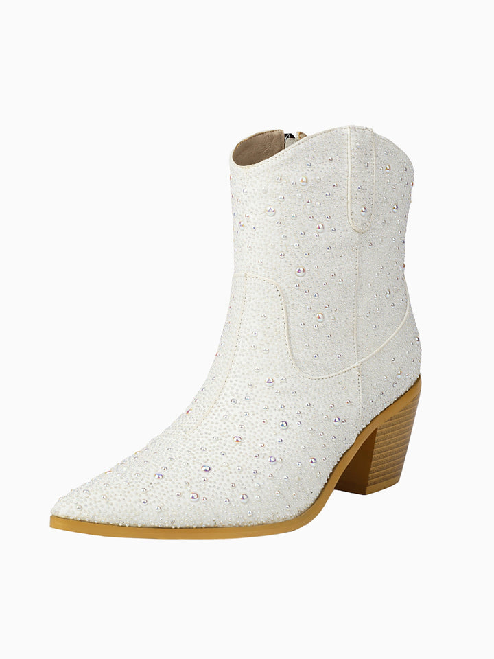 Stunning white cowgirl boots for women, adorned with intricate pearl and sparkling rhinestone designs. Bridal footwear.