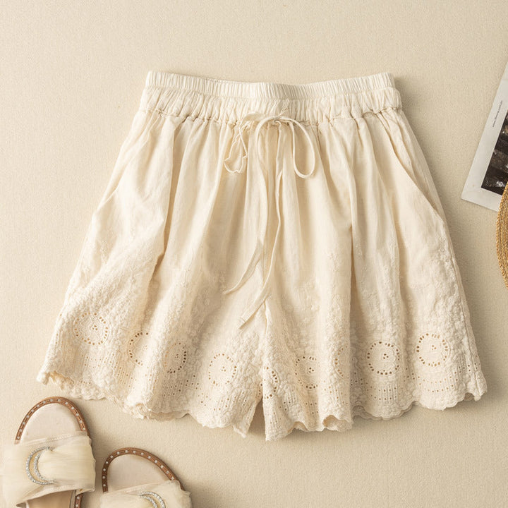 Beige relaxed fit women's shorts featuring comfy drawstring waist & elegant lace details. Ideal for summer.