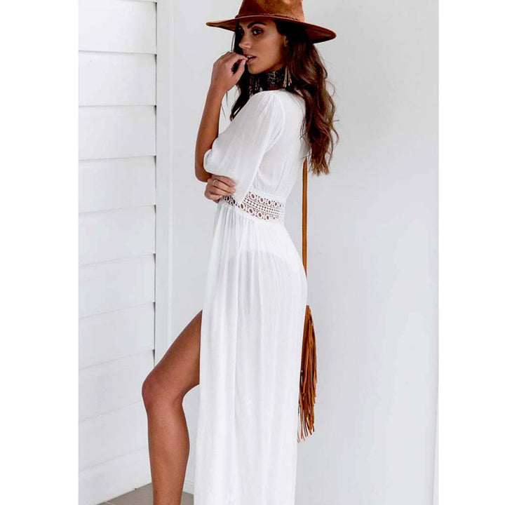 Elegant long blue beach dress for women with subtle lace accents and a charming bow tie closure, great as a swim cover-up.