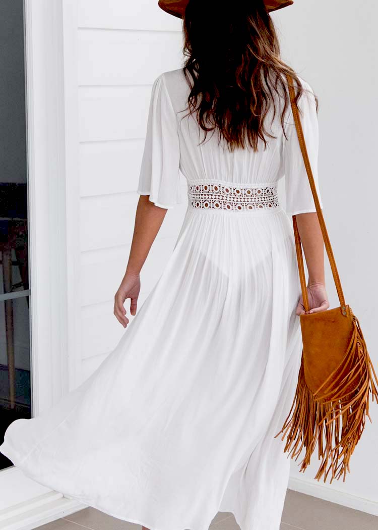Black women's long summer dress with intricate lace, a relaxed fit, and a stylish bow tie, perfect for beach vacations.