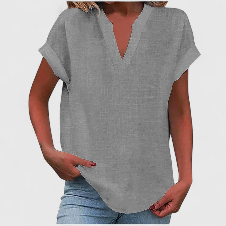Effortless White V-Neck Top, a loose fit women's blouse with cap sleeves for versatile style.