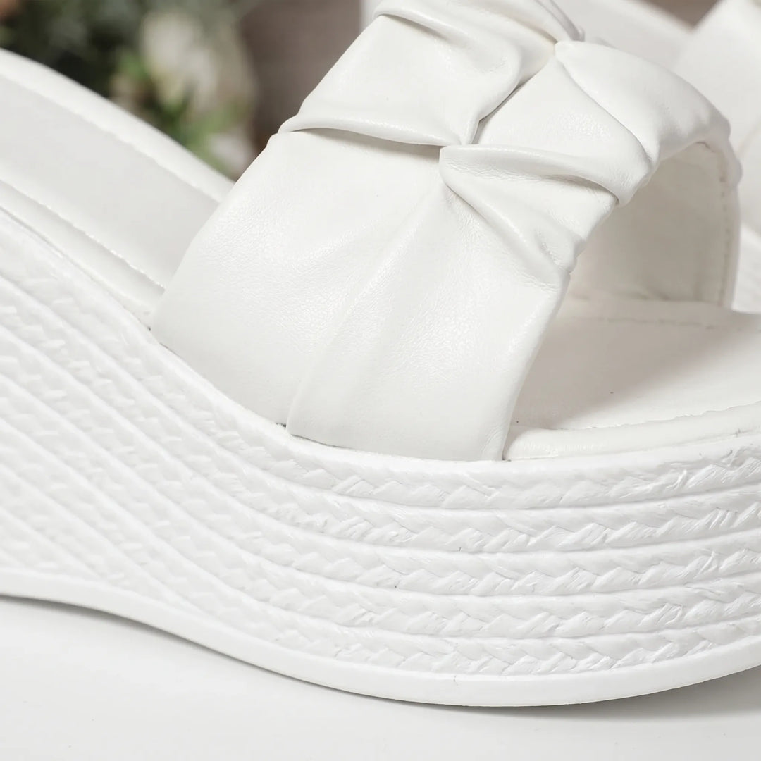 Comfortable women's slip-on sandals featuring a chunky white platform wedge heel & open toe for summer style.
