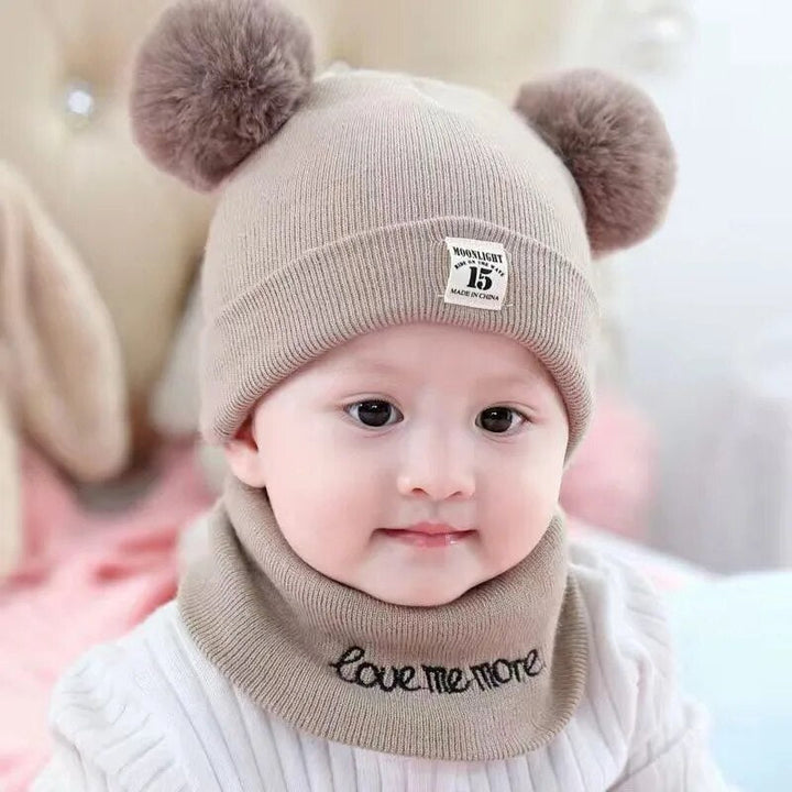 Soft cotton children's beanie in pink with a contrasting pom-pom, essential toddler apparel