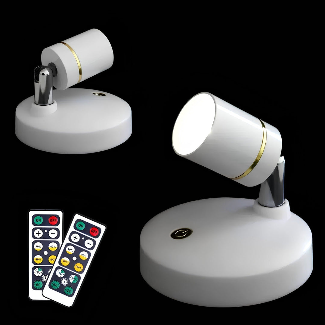 Hand holding a LumaSpot wireless LED accent spotlight, demonstrating its compact size.