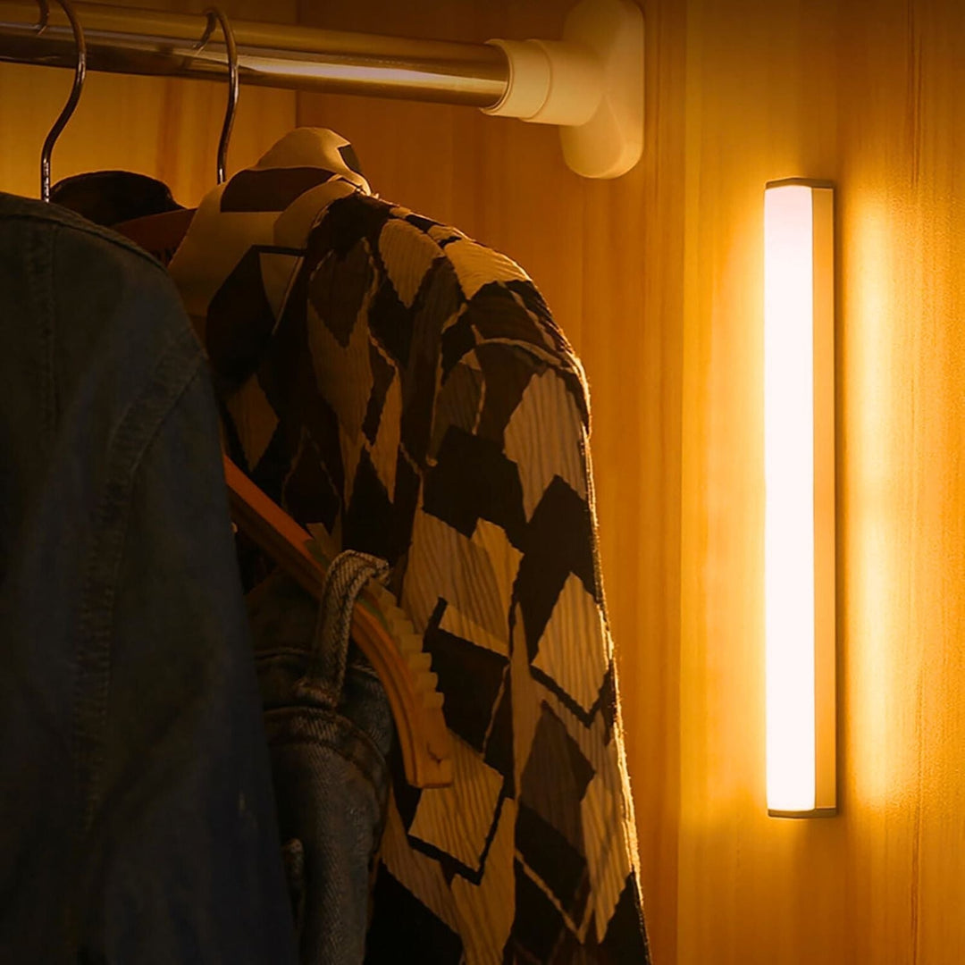 Battery-powered LED light bar with automatic motion sensing, ideal for cabinets, closets, and stairway lighting.