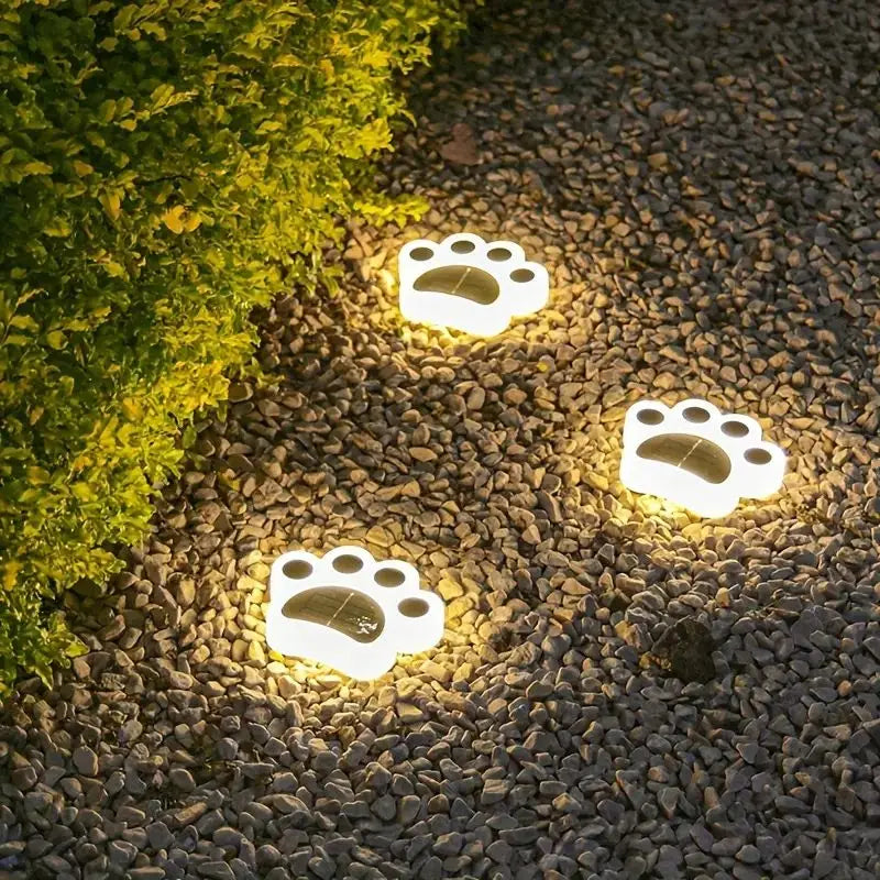 Wireless solar paw print garden lights illuminate outdoor pathways with warm white LED light for charming yard decor.