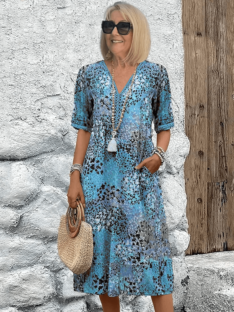 Women's Ocean Breeze flowing summer dress on a beach, showing its perfect casual elegance for vacation wear.