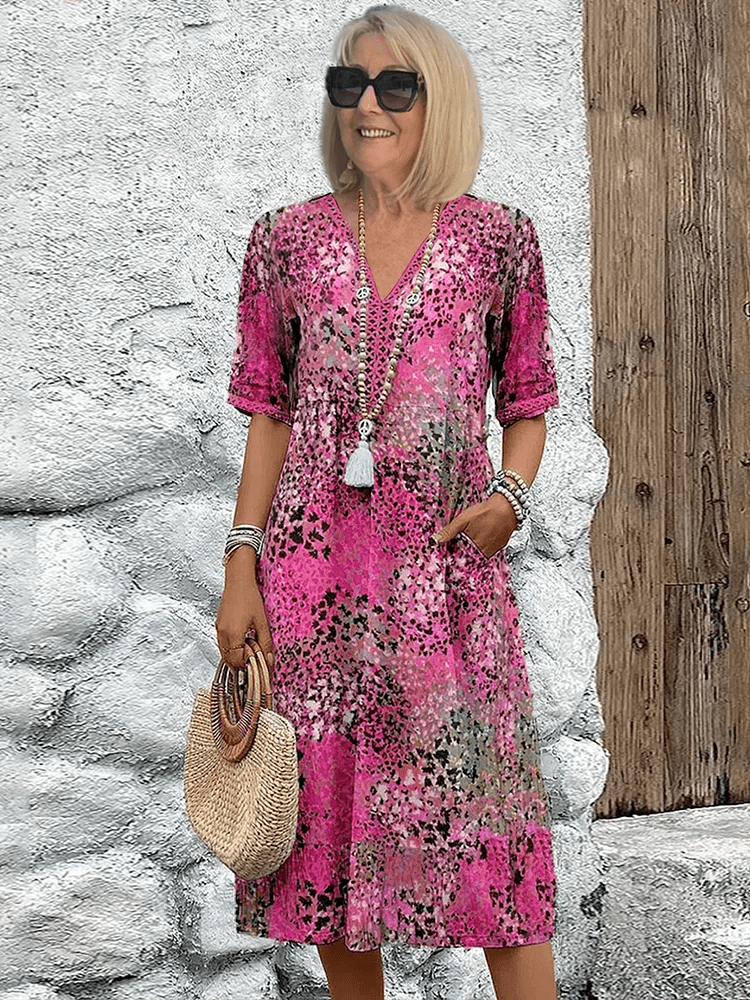 Back view of a woman wearing the relaxed fit Ocean Breeze flowing summer dress, suitable for any warm weather occasion.