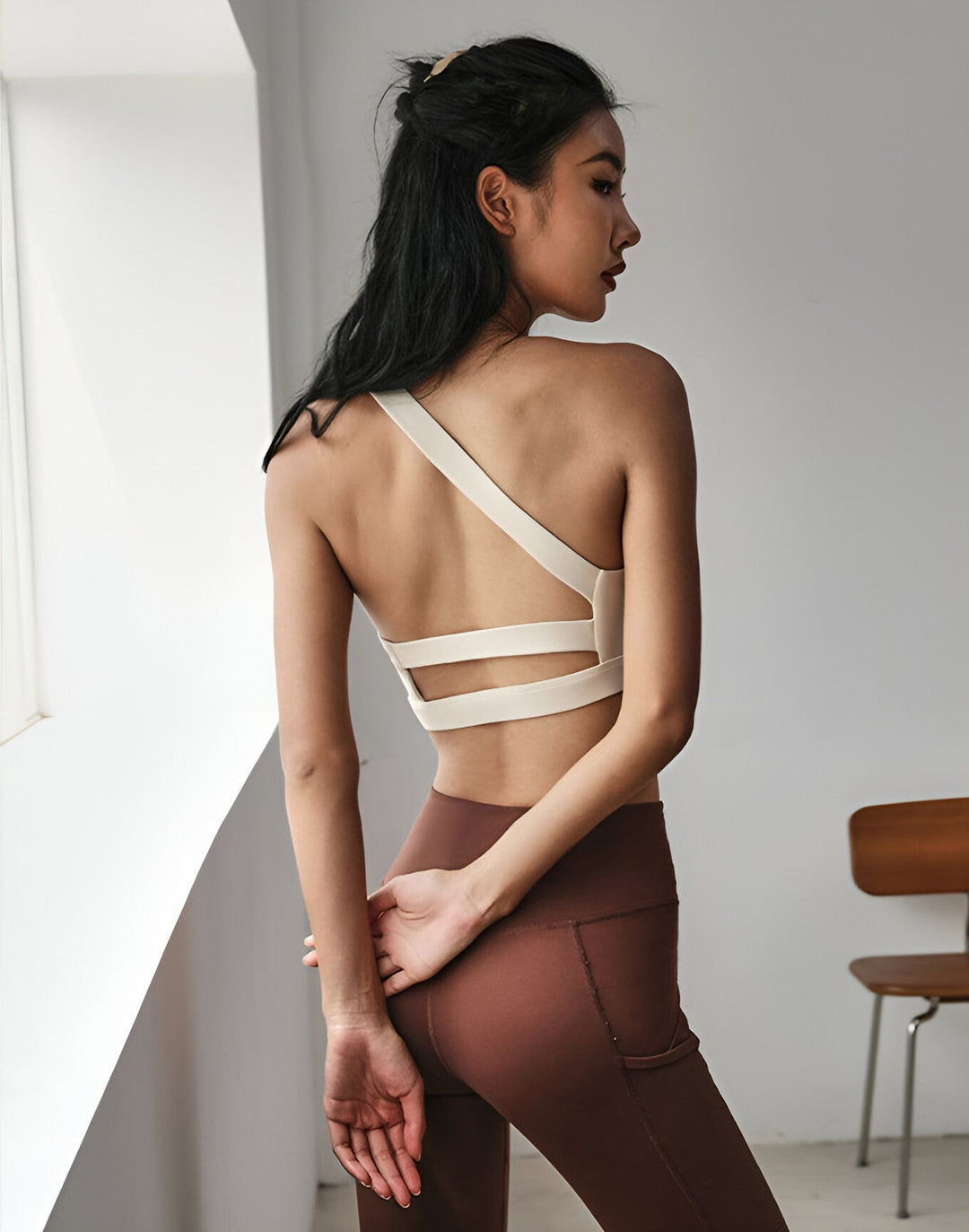 Close-up of breathable asymmetrical sports top fabric, showcasing its quick-dry texture.