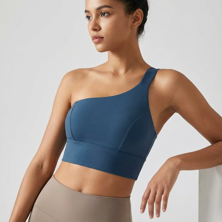 Full-body image of woman wearing a black asymmetrical sports top, perfect for active lifestyles.