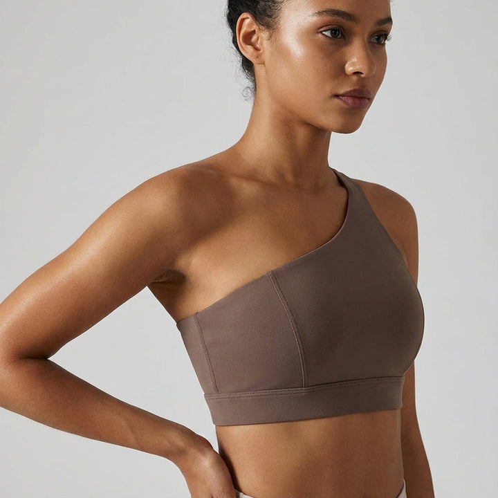 Black asymmetrical sports top, women's fitness apparel, quick-dry fabric for ultimate comfort.