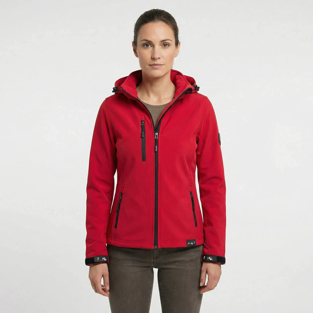 Active woman hiking in a lightweight, windproof hooded softshell jacket, ideal for spring & fall outdoor adventures.