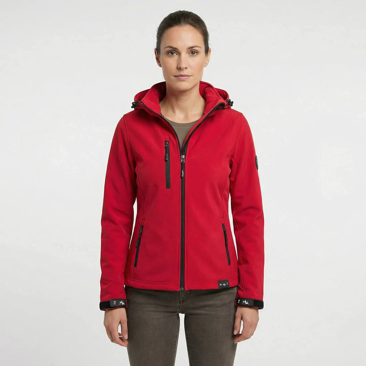 Active woman hiking in a lightweight, windproof hooded softshell jacket, ideal for spring & fall outdoor adventures.