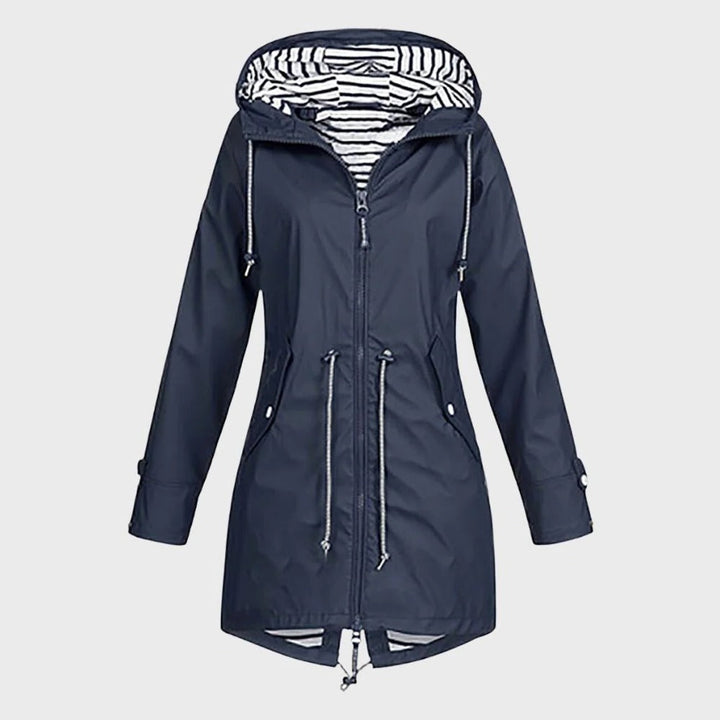 Close-up of a women's waterproof long coat, highlighting durable fabric and functional design for rain gear.