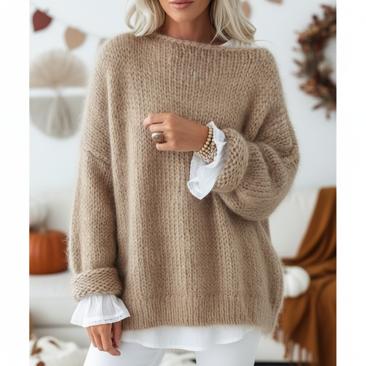 Woman wearing cozy oversized acrylic knit jumper perfect for casual autumn fashion.