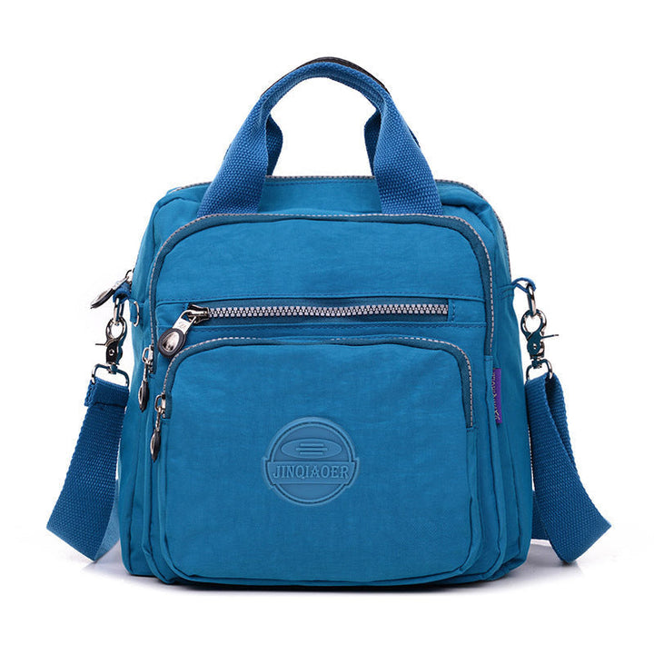 Durable women's waterproof travel bag, nylon construction, functions as shoulder, crossbody & backpack.
