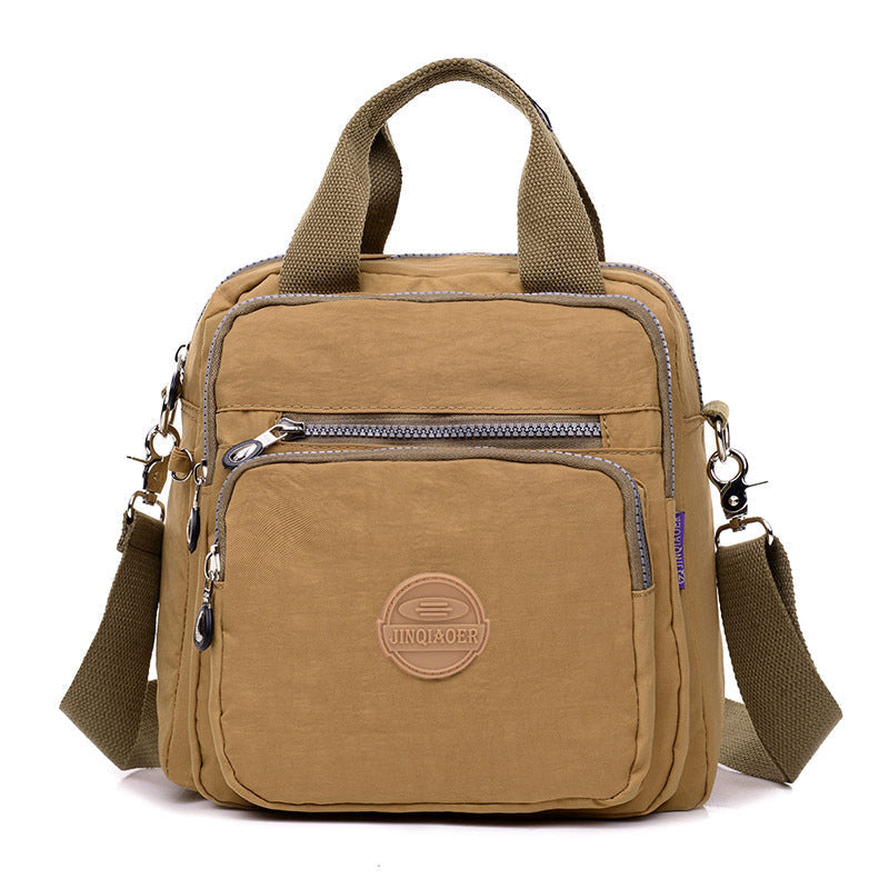 Women's waterproof crossbody bag, sleek design, ideal for travel, converts to shoulder bag or backpack.