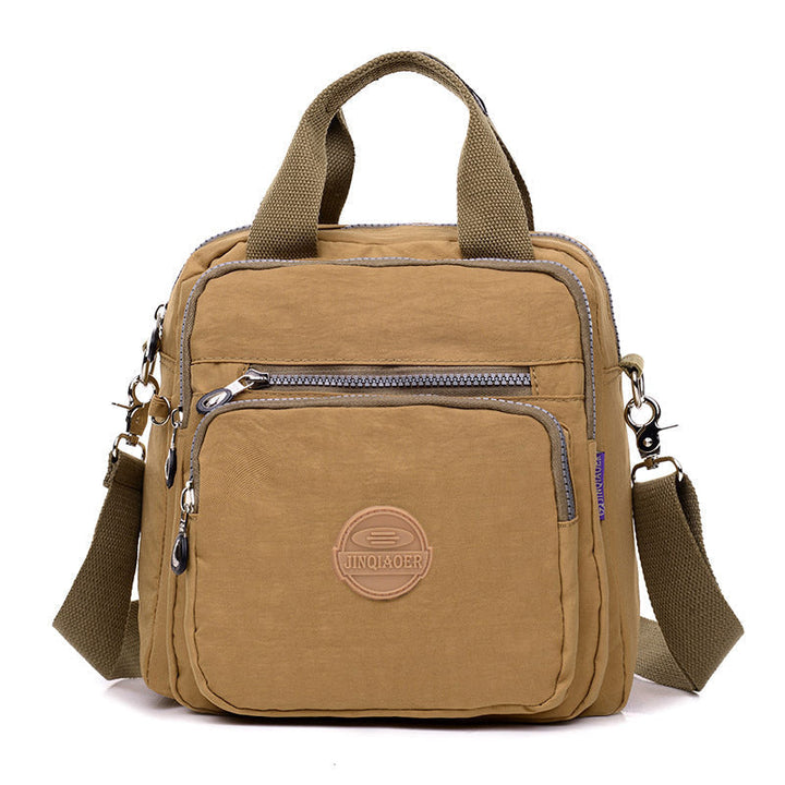 Women's waterproof crossbody bag, sleek design, ideal for travel, converts to shoulder bag or backpack.