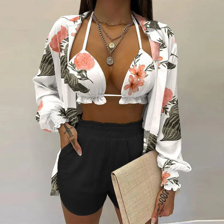 Women's vacation essential: tropical print bikini, side-tie shorts & breathable cover-up for beach days.