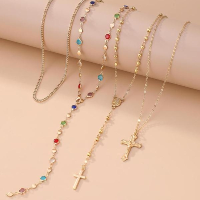 Intricate 4-piece women's layered necklace set, featuring various cross pendants & chains for a unique look.