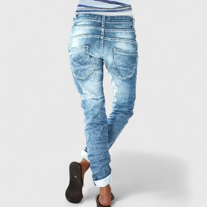 Vintage-style women's acid wash skinny jeans, tapered fit, visible contrast stitching, perfect for everyday wear.