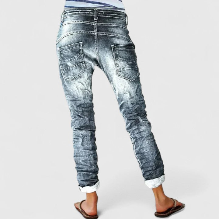 Casual women's acid wash skinny jeans featuring unique contrast stitching and a stylish button fly.