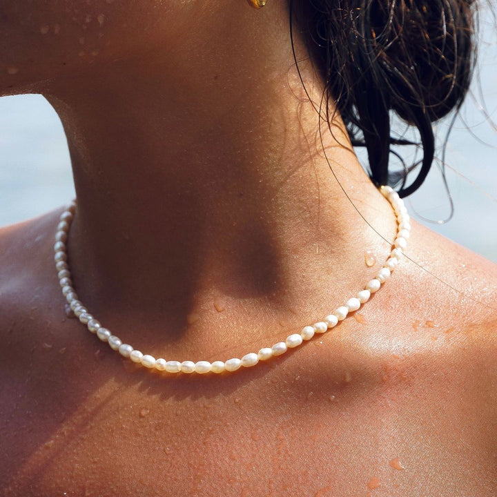Women's adjustable freshwater pearl choker necklace in elegant gold, delicate and water resistant jewelry.