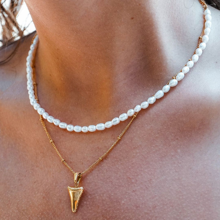 Adjustable gold choker necklace featuring delicate freshwater pearls, elegant and water resistant for women.