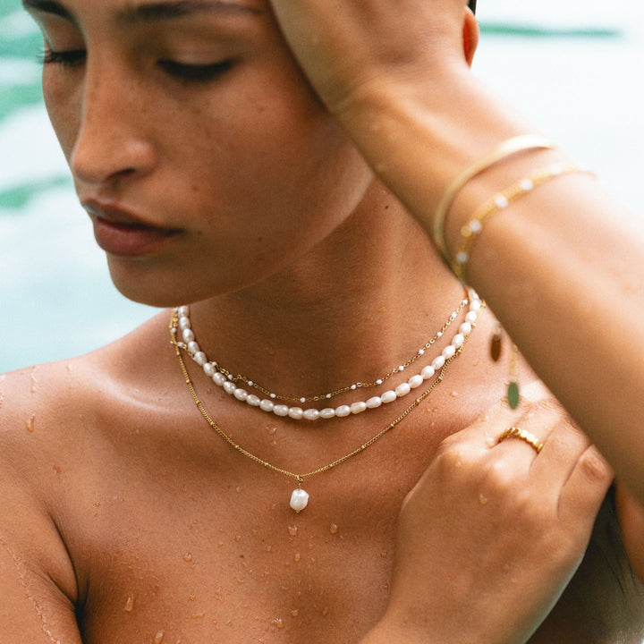 Adjustable clasp detail of a delicate women's freshwater pearl choker necklace in gold, hypoallergenic.