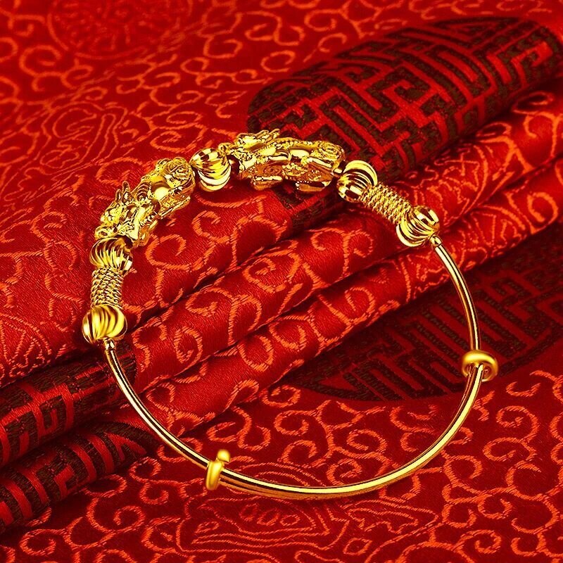 Women's gold charm bracelet with a beautiful good luck design, adjustable and elegant accessory.