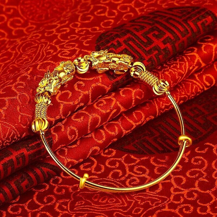 Women's gold charm bracelet with a beautiful good luck design, adjustable and elegant accessory.