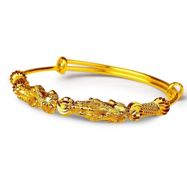 Versatile gold good luck charm bracelet, adjustable for women, adds a touch of elegance to any outfit.