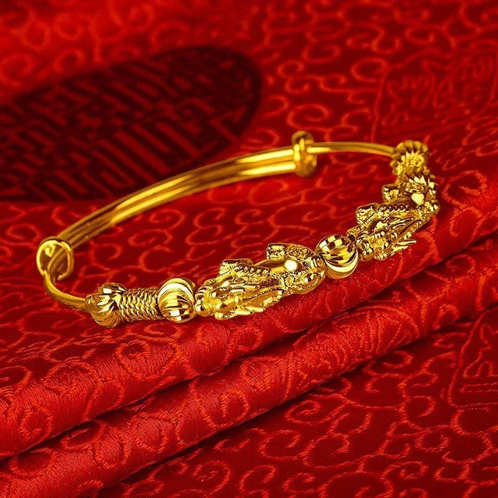Stylish women's adjustable gold bracelet with good luck charm, perfect for layering or as a stand-alone piece.