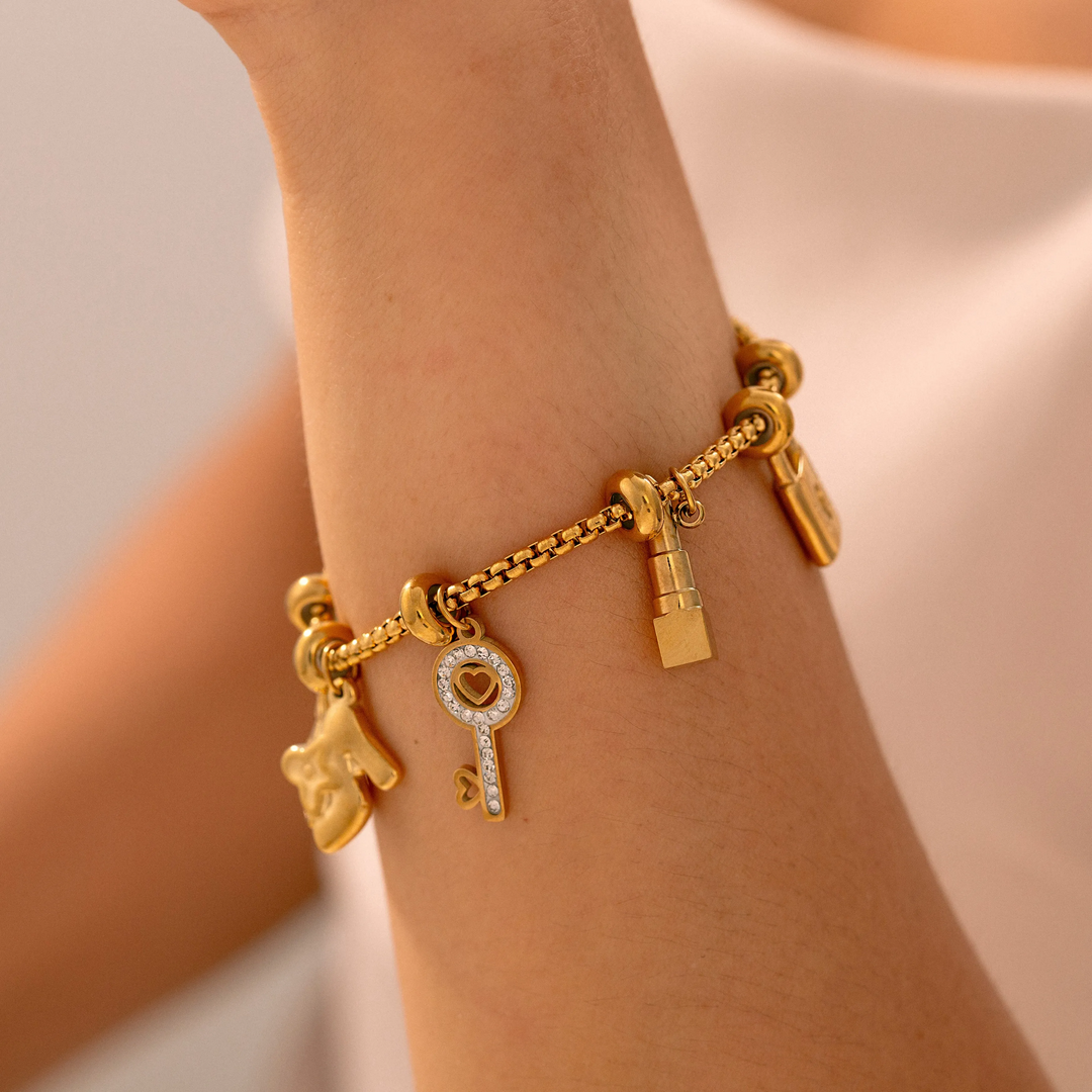 Versatile women's adjustable charm bracelet, gold & silver finish, sparkling rhinestone accents.